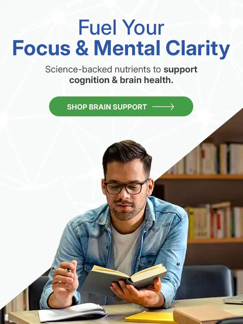 A man with glasses reading a book.